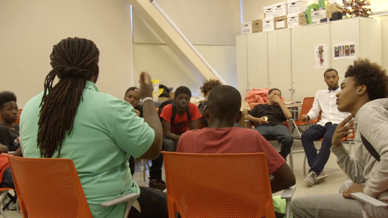 Ashanti Branch, founder of Powered grantee Ever Forward, leads a young men's group session