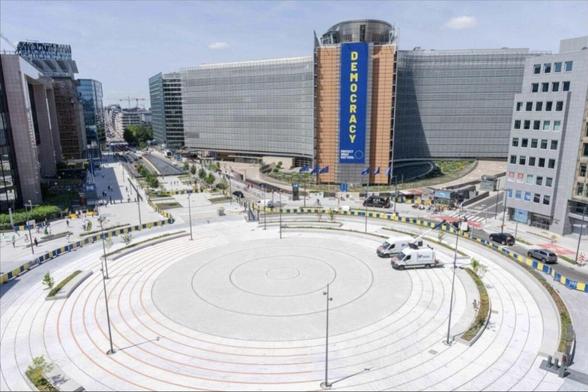 Photo of big circle of concrete with the HQ in the background.