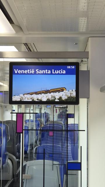 Photo of screens in commuter train showing destination Venice
