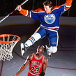 An AI image of an Oilers player resembling Wayne Gretzky leaping above a Bulls player resembling Michael Jordan beside a basketball hoop, holding a hockey stick.
