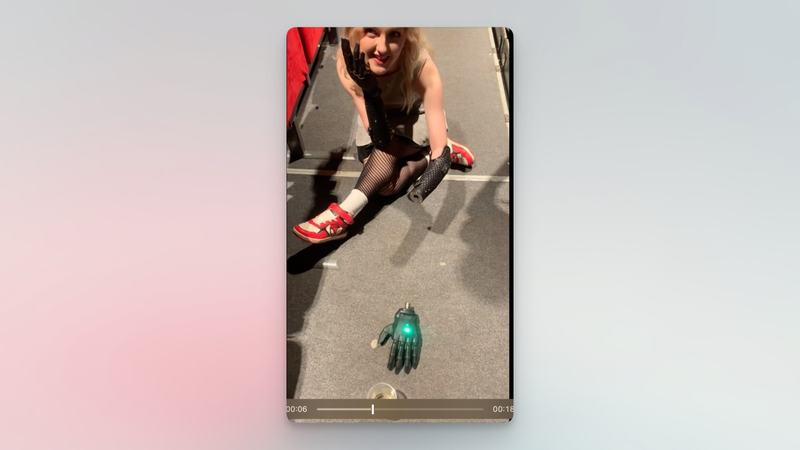 A wireless prosthetic hand beside a glass of champagne, from the original demonstration clip.