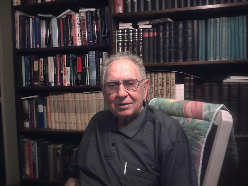 Dad in front of his library