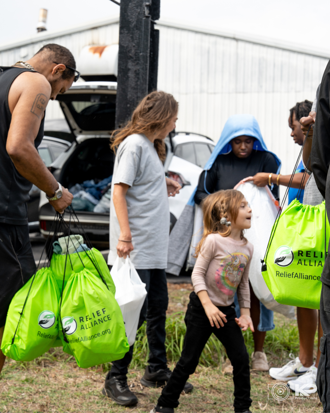 Volunteers with Relief Alliance serving hot meals to individuals experiencing homelessness in Central Florida