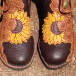 Sunflower embroidered moccasins with intricate beadwork and leather details.