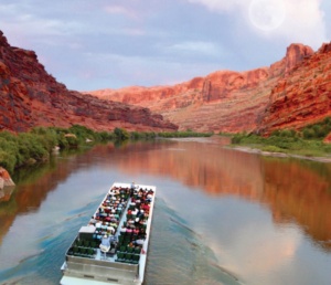 Group of visitors laughing and enjoying the guide's narration on the Sound and Light Show jet boat tour