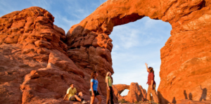 Tour guide pointing out arch formation in Arches National Park