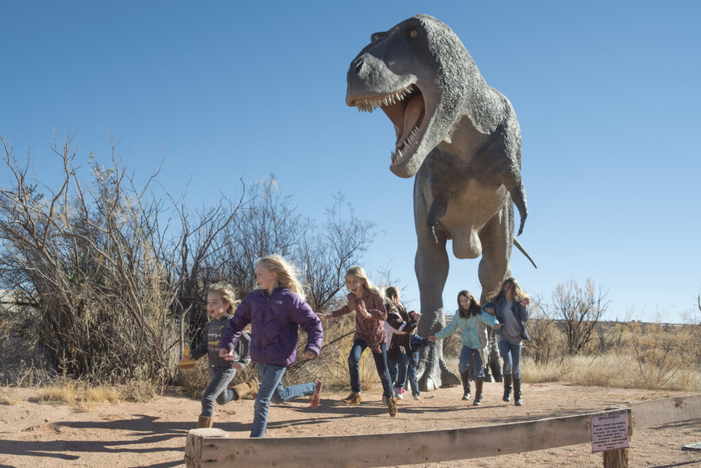 Kids playing near giant T-Rex replica at Moab Giants