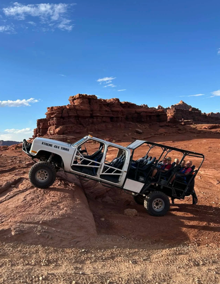 guests sitting in modified 4x4 on Hurrah Pass trail with Colorado River canyon views