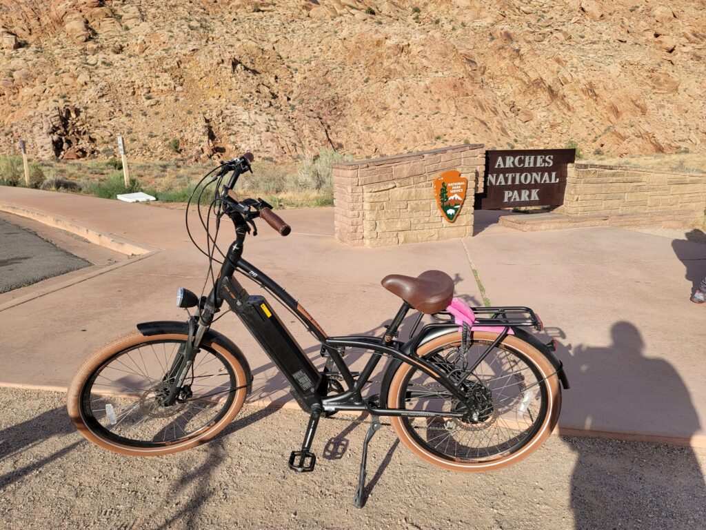 Magnum Beach Cruiser e-bike near Arches National Park sign