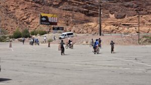 Large group of e-bike riders leaving parking lot for Moab trailhead