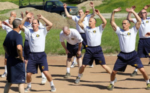 A basic recruit academy student, center, takes a breather during fitness training in the 151st class at the Alameda County Sheriffs Office Regional Training Center in Dublin, Calif., on Monday, March 17, 2014. Academy graduates pass a rigorous physical fitness training program and are fit when hired by police departments around the state; however, very few departments require veteran officers to maintain a high level of fitness. (Jim Stevens/Bay Area News Group)