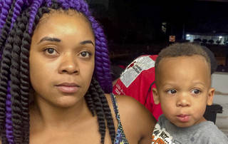 Takia Harding hold her son Tyree Polite, 2, who she had to drop from the second floor apartment to by rescued from a fire. Polite was caught by Oklahoma City Police Officer Anthony Glover in the rescue. 

photo by Robert Medley