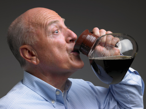 Senior man drinking coffee from pot