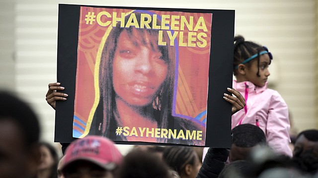 SEATTLE, WA - JUNE 20: A woman holds a sign in honor of Charleena Lyles during a protest and rally in honor of Lyles on June 20, 2017 in Seattle, Washington. Officers from the Seattle Police Department shot and killed Lyles, a pregnant mother of four, on June 18.  (Photo by David Ryder/Getty Images)