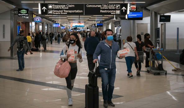 Travelers wearing masks try to reduce the risk of contracting coronavirus. (Wikipedia)