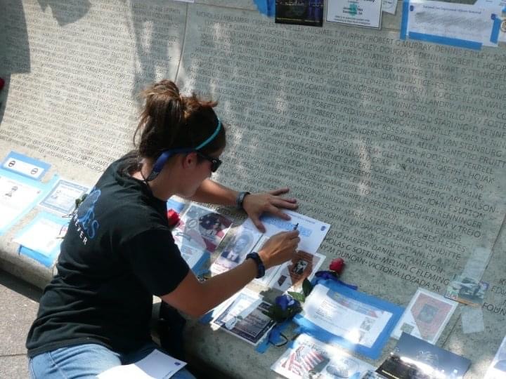 Katie sketching her father's name at the National Law Enforcement Memorial.