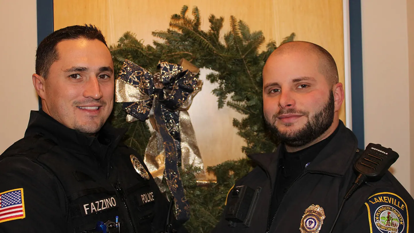 Officers Weston Fazzino (left) and Rob Schiffer (right) delivered several packages to their rightful homes in Lakeville, Massachusetts, last week. (Courtesy of Lakeville Police Department)
