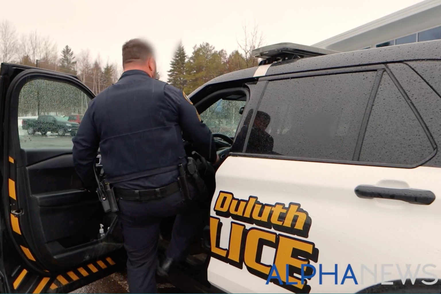 member of the Lake Superior Drug and Violent Crime Task Force enters his squad car during a recent shift. (Alpha News)