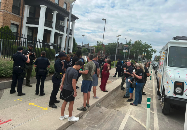 Police officers are served free ice cream by a retired cop after a local shop refused them service. (Bryan Ede Facebook)
