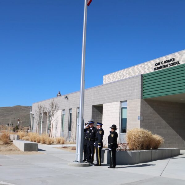 Police Honor Guard flag-raising ceremony at John C. Bohach Elementary School. Photo courtesy of the Nevada State Police Highway Patrol.)