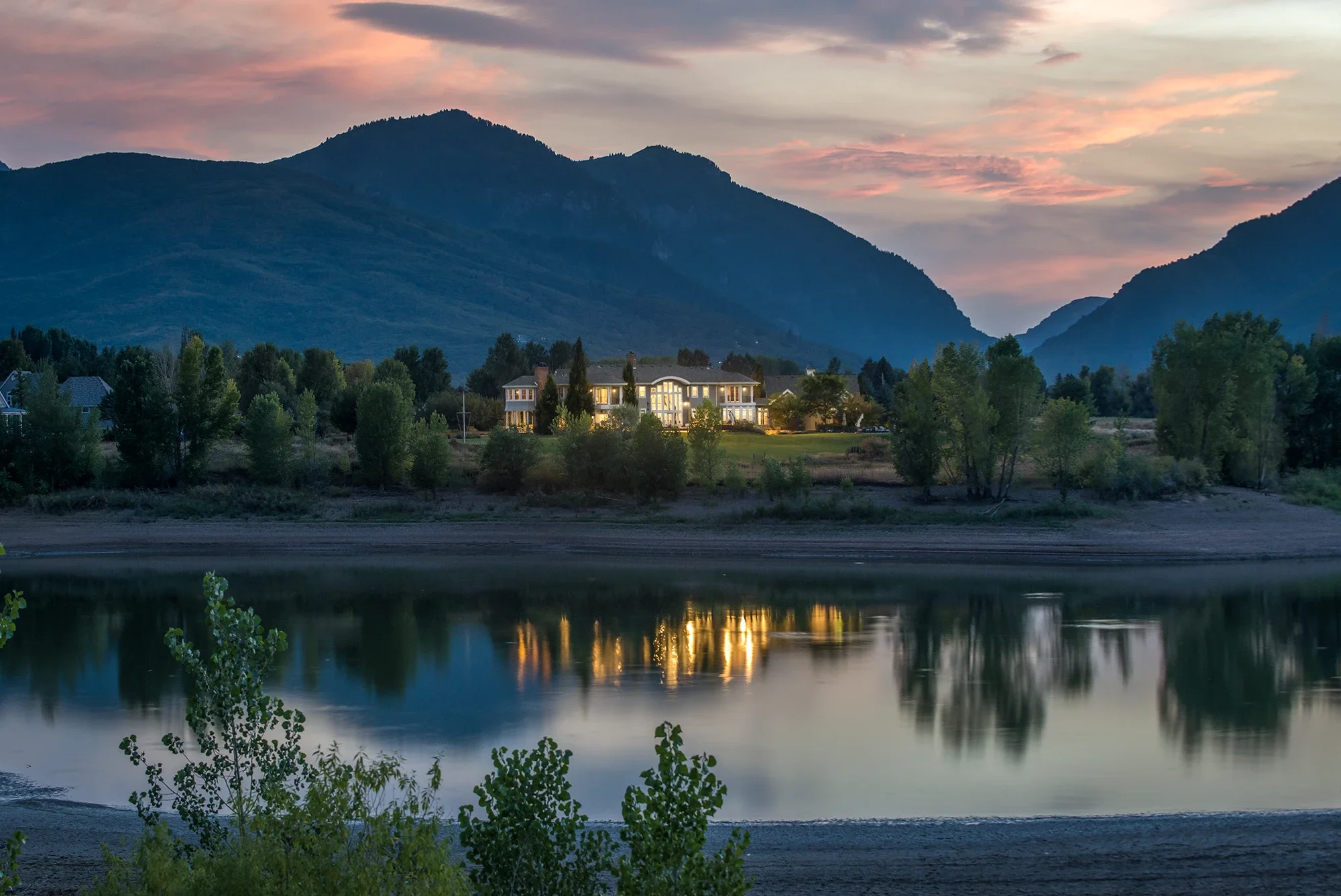 A lakefront home basks in the glow of the sunset on Pineview Reservoir.
