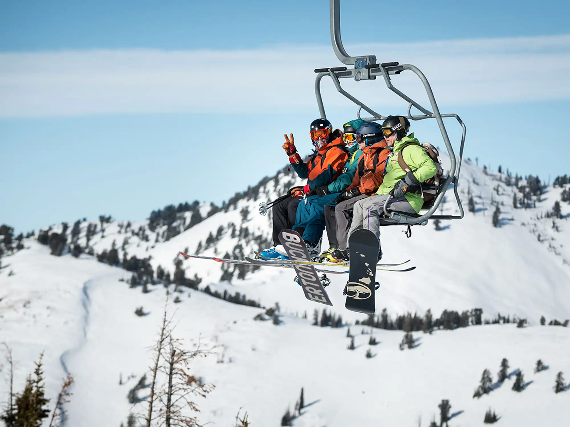 A skier gives the peace sign from Powder Mountain's Hidden Lake Express
