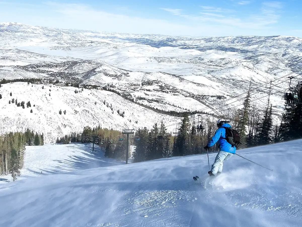 An image of a skier skiing down the mountain at Deer Valley in Park City, Utah
