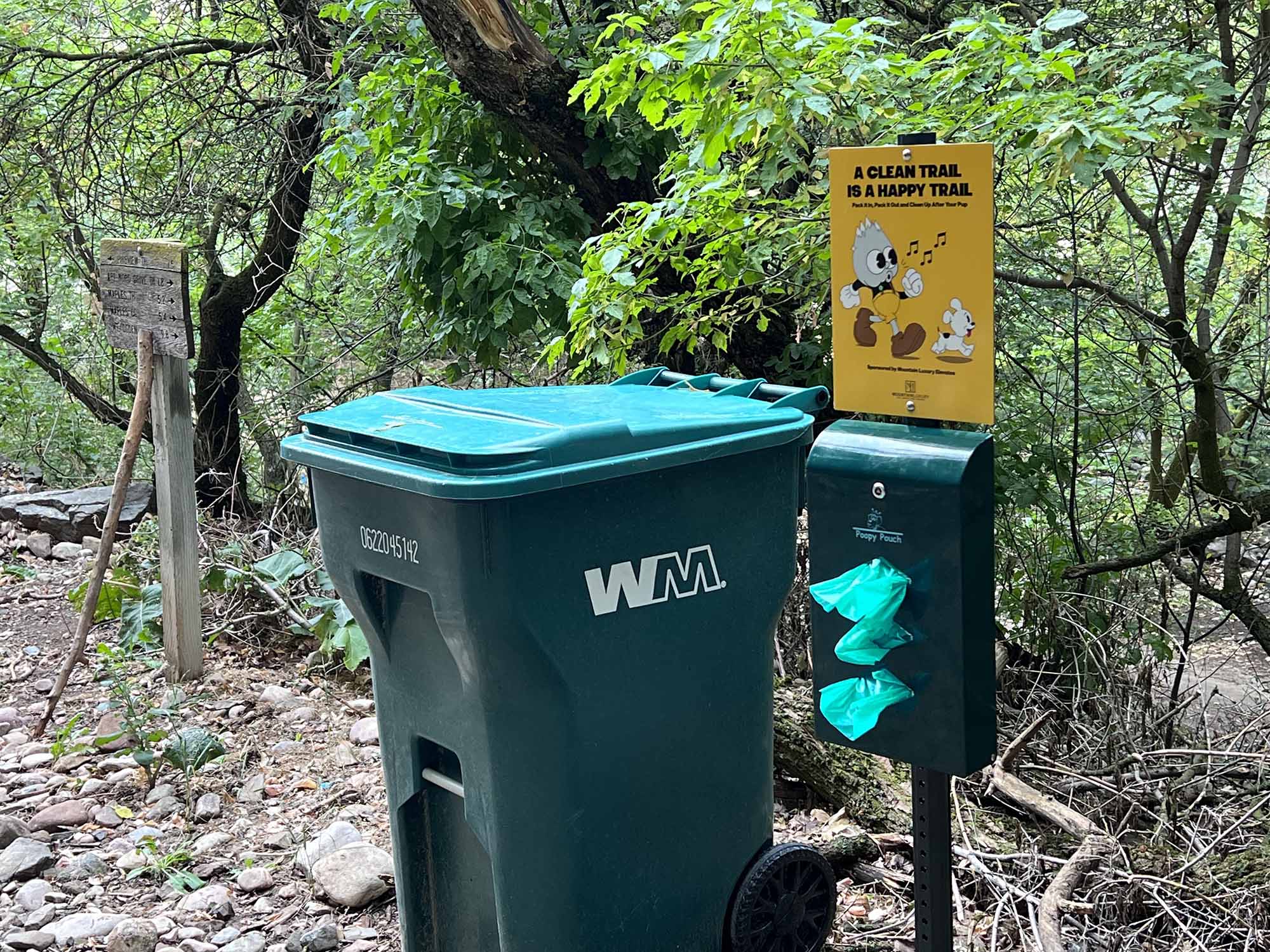 The trash can and sign at Wheelers Creek Trailhead.