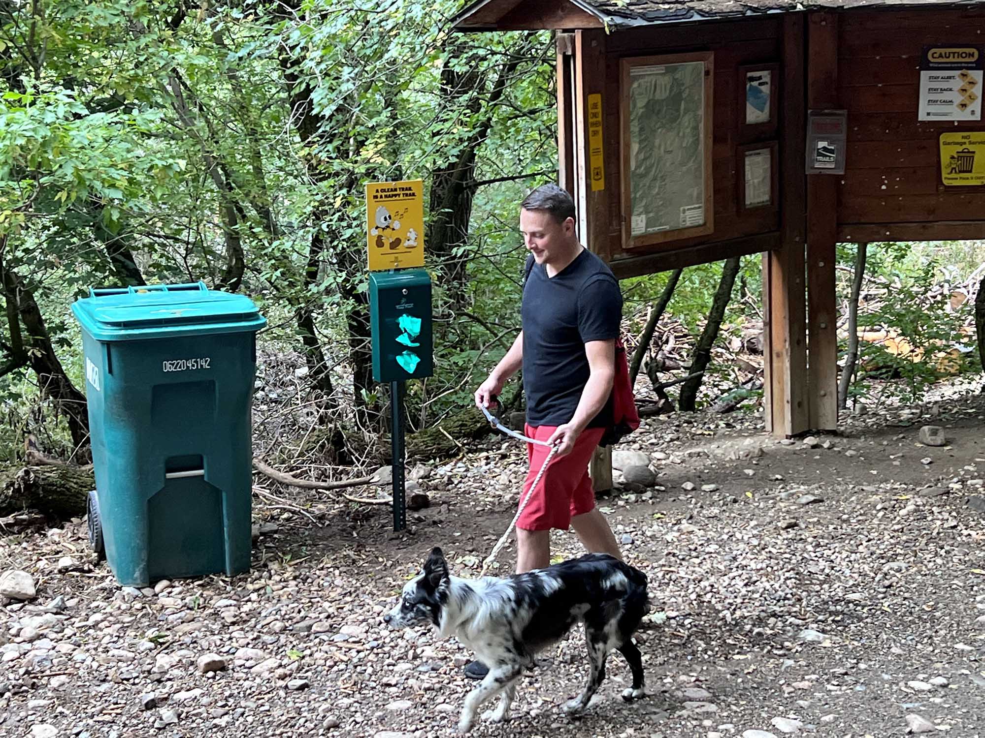 Carson Cherry walking his dog Cooper at Wheelers Creek Trailhead.