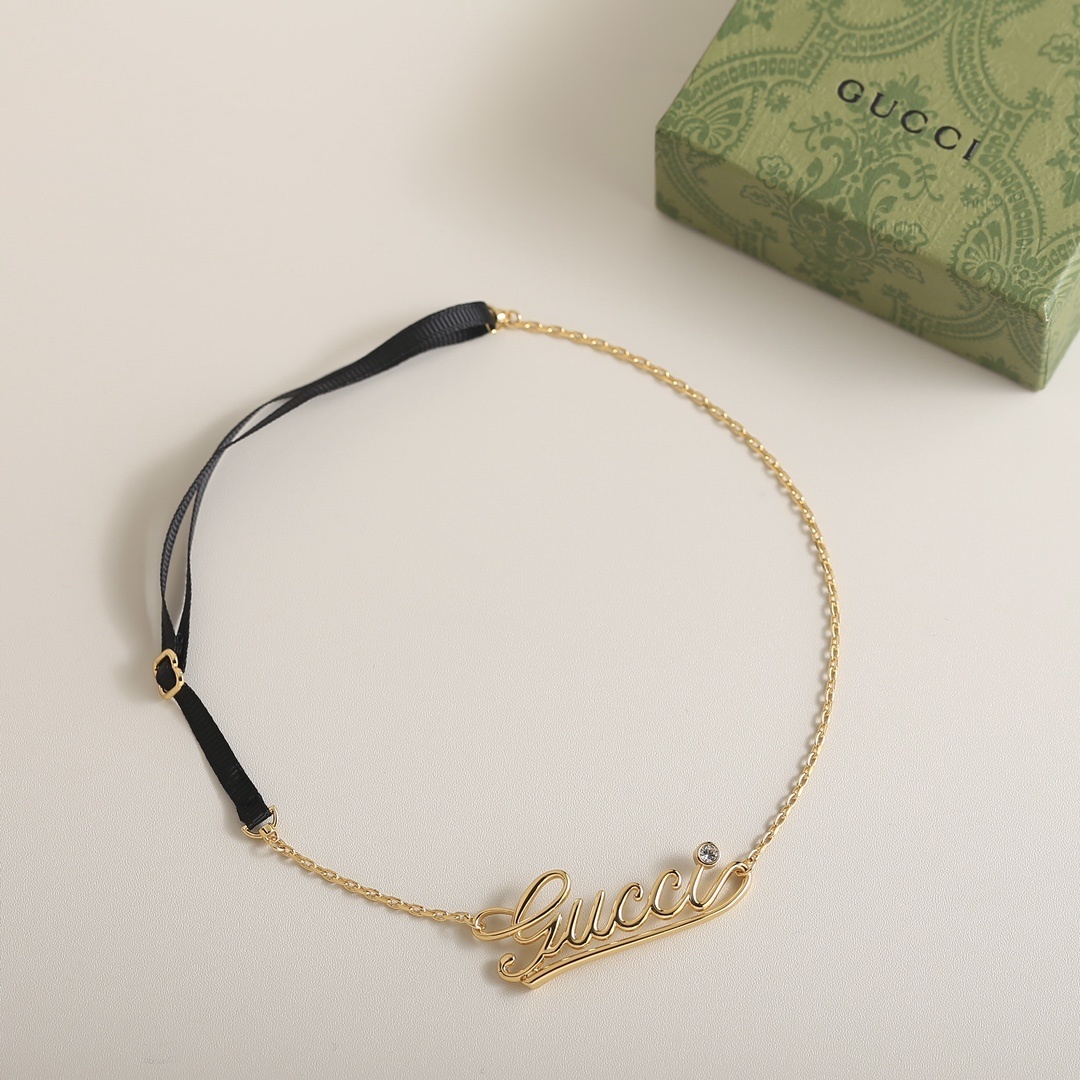 Gucci Gold Script Necklace – Black Ribbon Accent