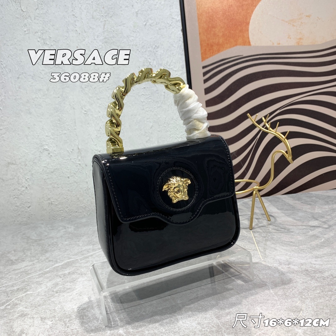 Versace Black Patent Medusa Handbag with gold chain handle and Medusa logo on a display.