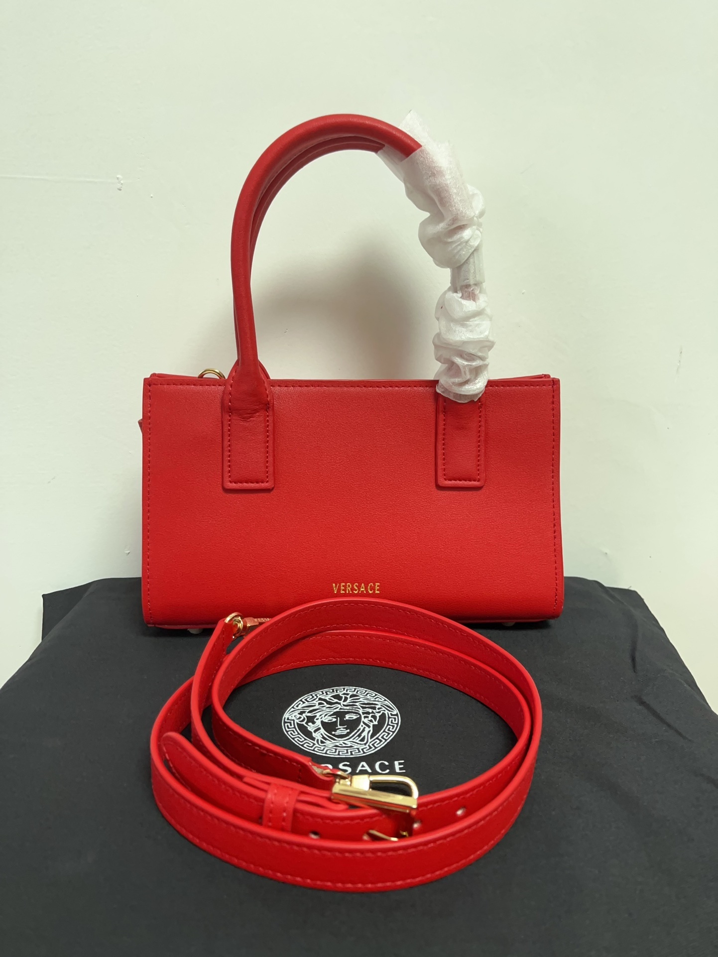 Versace Red Mini Tote bag with adjustable strap and dust bag on white background