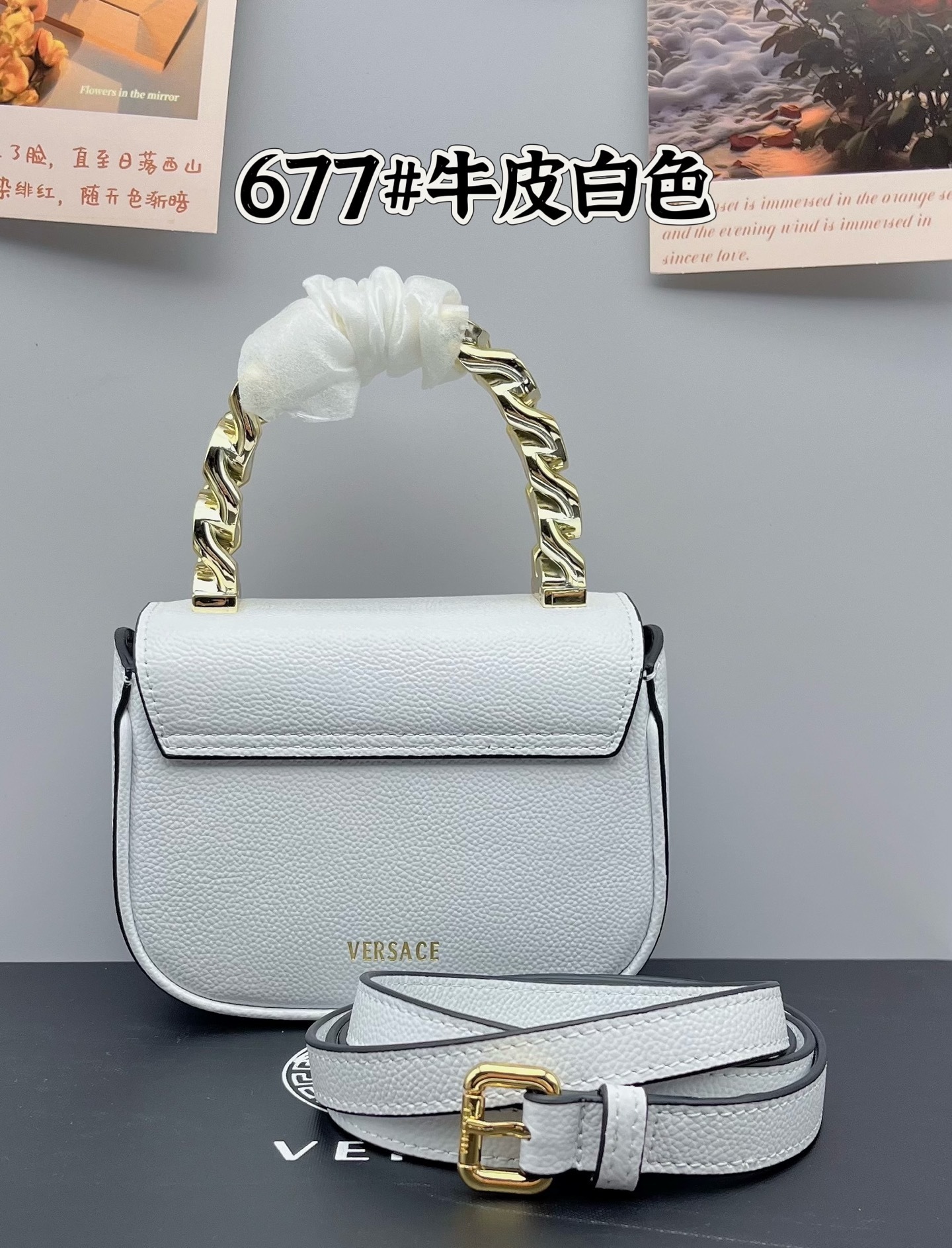 Versace White Mini Leather Bag with gold chain handle and adjustable strap on a dark surface.