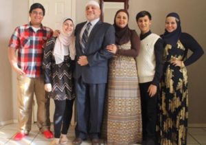 Imam Enchassi and his family. You can tell they're terrorists because his wife and daughters dress modestly, and he wears a funny hat. 