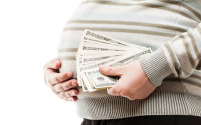 pregnant woman holding dollar currency cash