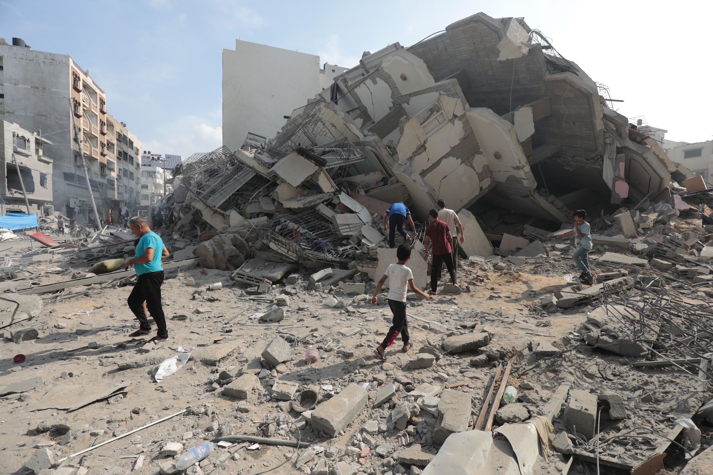 palestinians inspect the ruins of aklouk tower destroyed in israeli airstrikes in gaza city