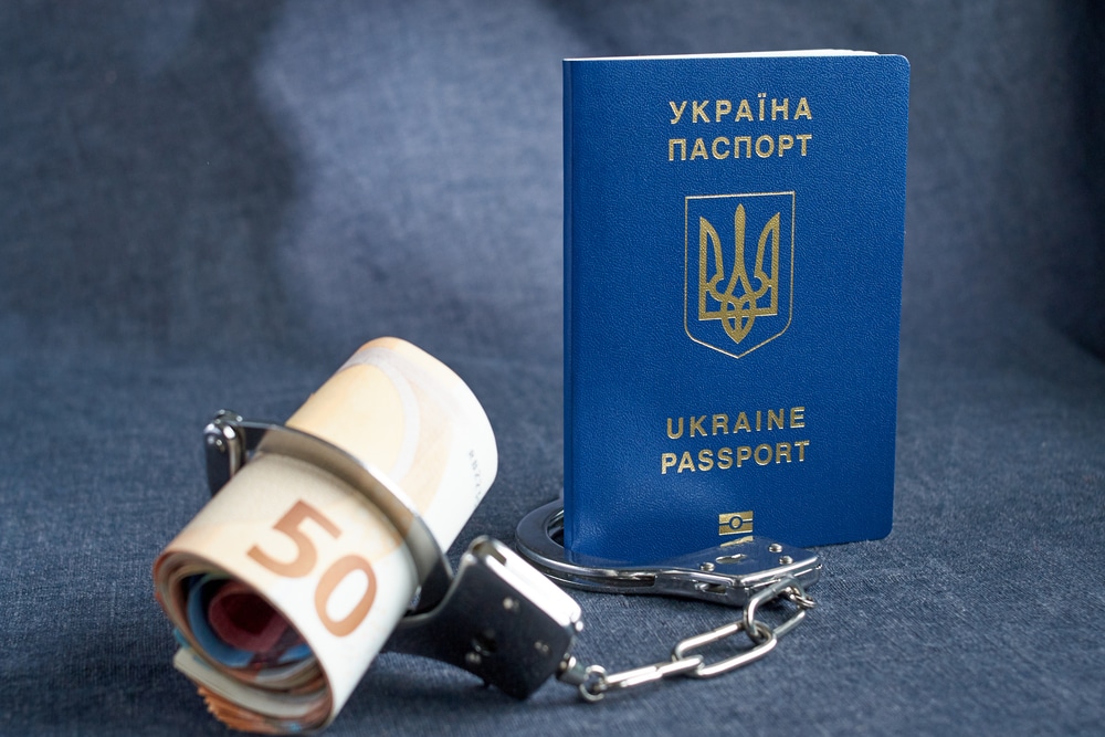 ukrainian biometric passport and handcuffs on the table.