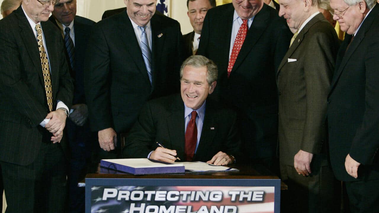 us president george w bush shares a laugh with memebers of congress as he signs the renewal of the usa patriot act at the white house in washington