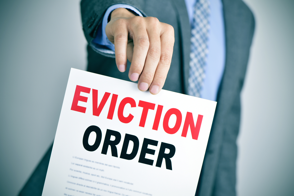 man in suit with an eviction order