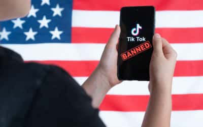 a teenager holds a smartphone with the tiktok logo and against the background of the american flag. selective focus. donald trump to ban tiktok in united states. russia, kazan august 08, 2020