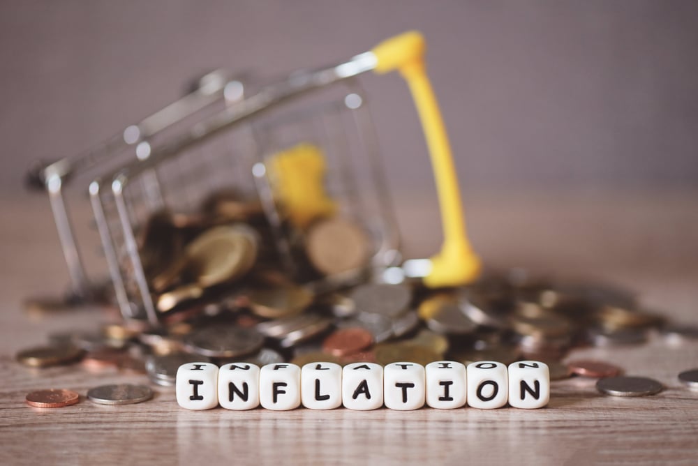 inflation with coin and shopping cart on wooden background, busi