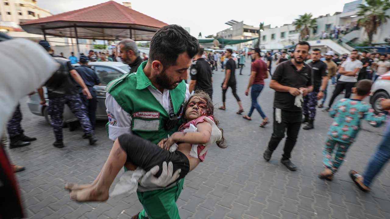Medics transport an injured Palestinian child into Al-Shifa hospital in Gaza City following an Israeli airstrike on October 11, 2023. (Photo by Wafa/Licensed under CC BY-SA 3.0 DEED)