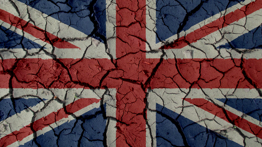 political crisis or environmental concept: mud cracks with uk flag