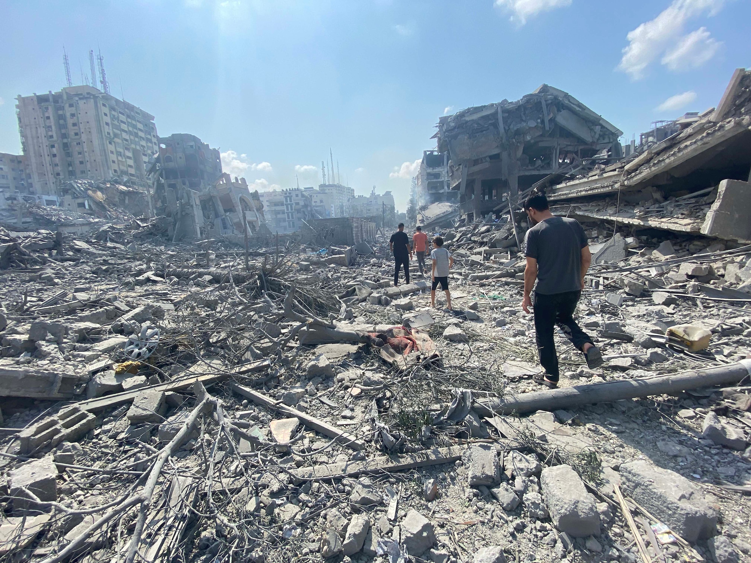 palestinians inspect the damage following an israeli airstrike on the el remal area in gaza city