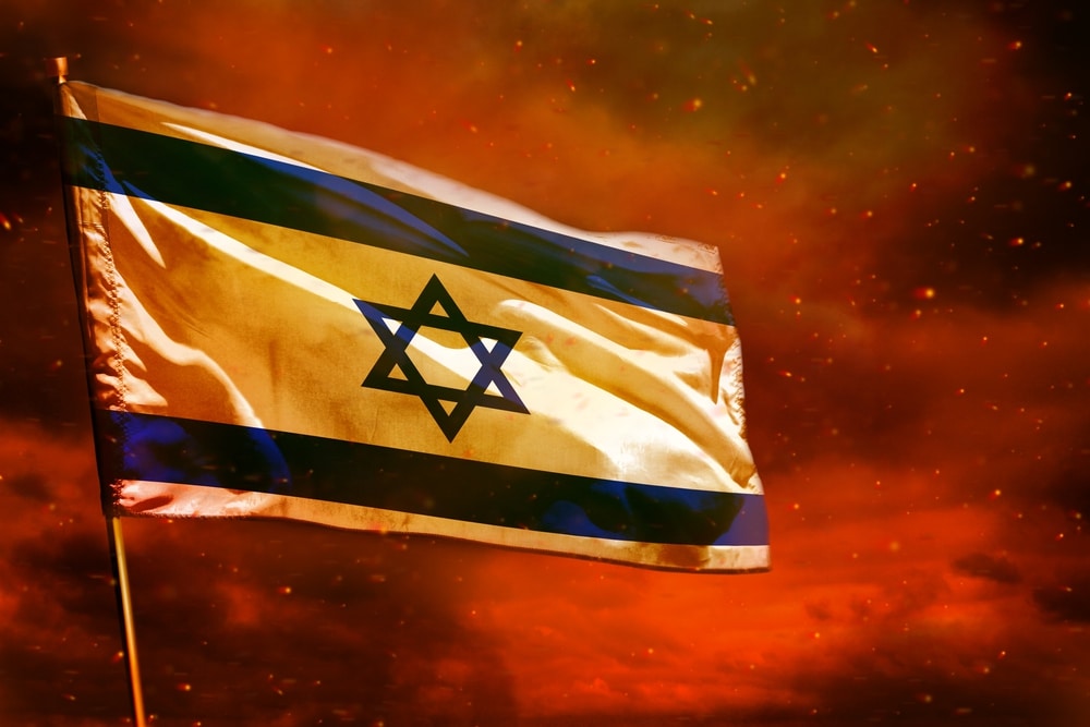 fluttering israel flag on crimson red sky with smoke pillars background. troubles concept.