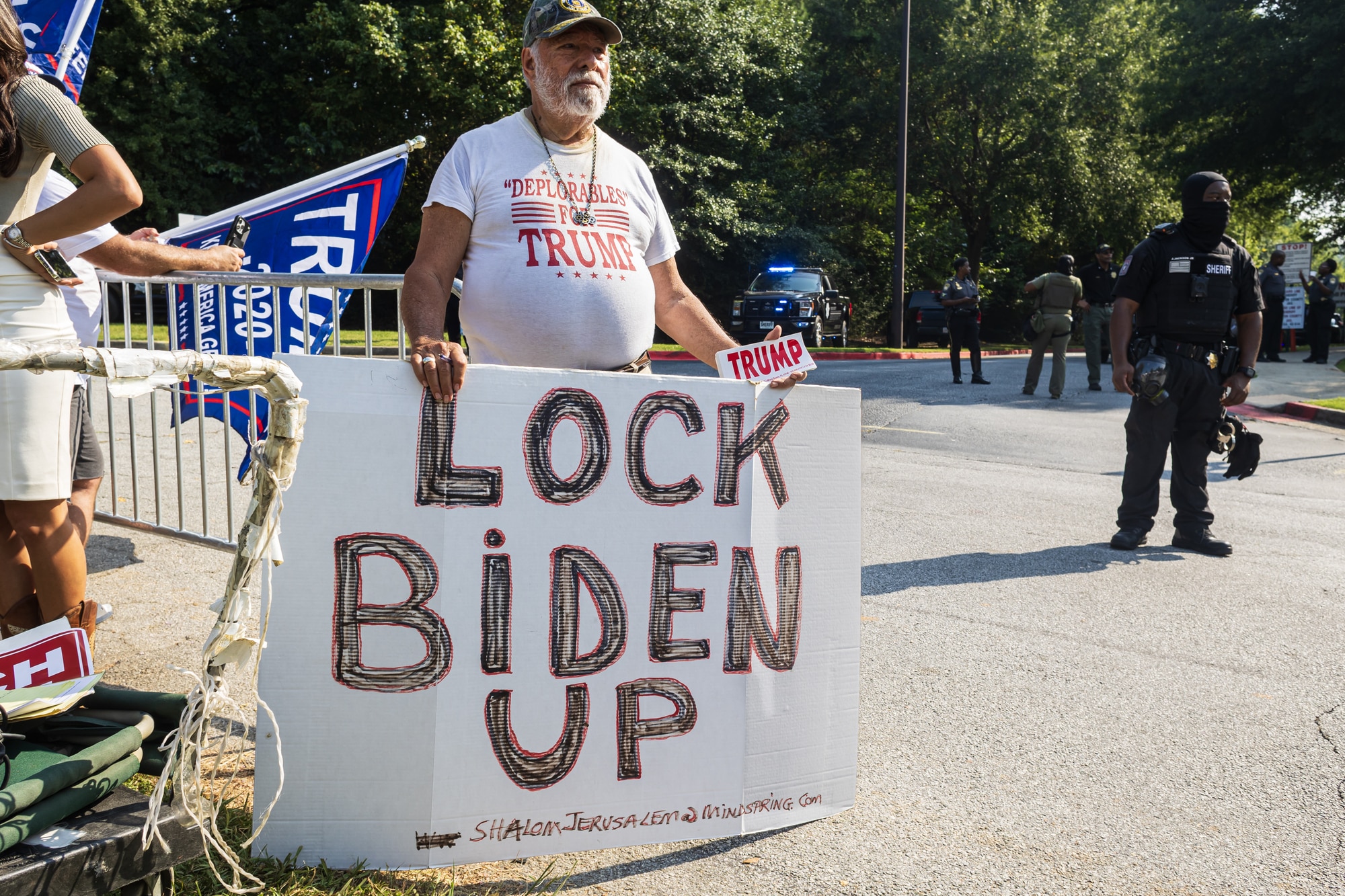 trump supporter holds anti joe biden sign outside atlanta jail