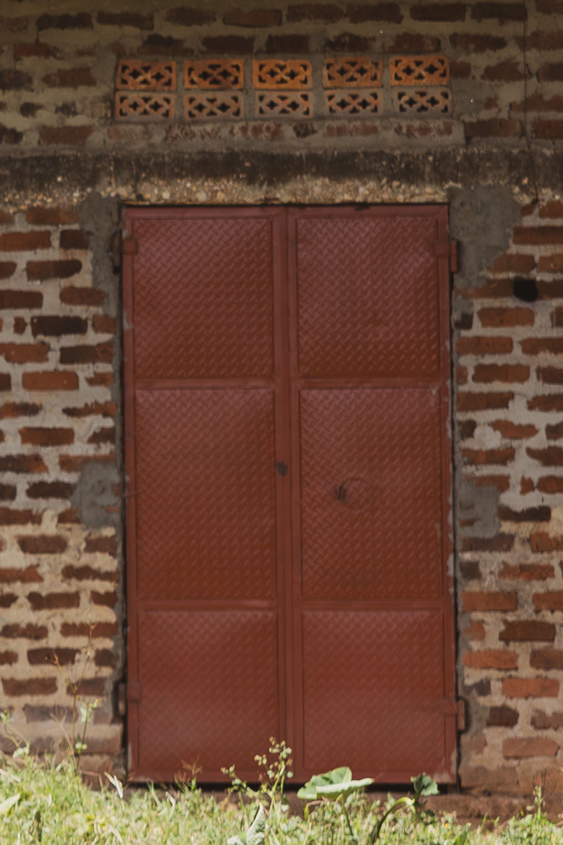 Red Metal Door and Brick Vents