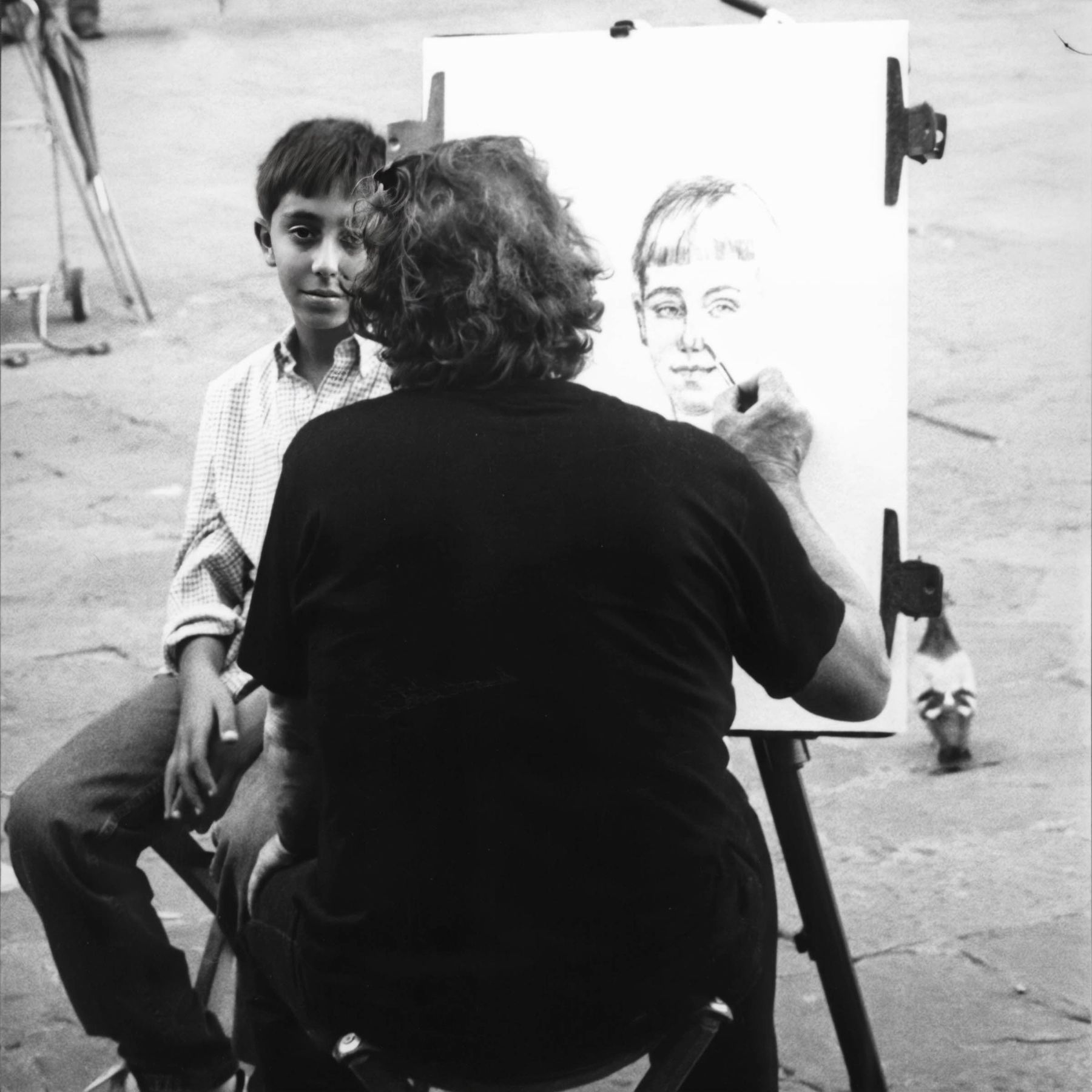 Young Boy Has Portrait Drawn in Piazza 