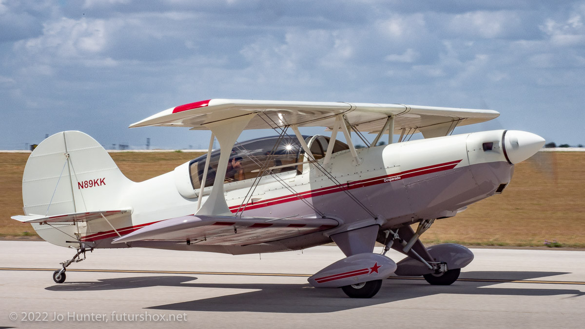 An airplane: EAA  Acrosport 2 taken during KBAZ 4th July Fly-In