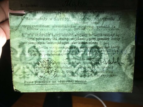 bluish-gray-green paper held up to light revealing a watermark consisting of a row of crowned Polish eagles across the bottom